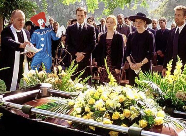Nealocrats and Georgicans - Above: A Nealocrat attending a somber funeral. Most assuredly, this did not put the "fun" back in "funeral." It did, however, put the "uncomfortable" back in "uncomfortabuneral".